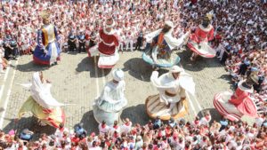 Colourful dancers surrounded by a crowd in Pamplona, Spain.