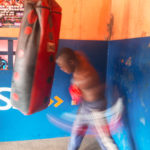 A boxer works the heavy bag in Accra, Ghana. Copyright: Leo Hopkinson. 